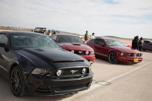 Cars on the race track and on the roads of the desert photo