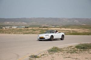 Cars on the race track and on the roads of the desert photo