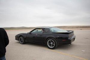 Cars on the race track and on the roads of the desert photo