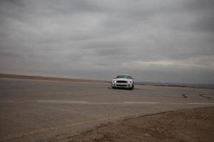 Cars on the race track and on the roads of the desert photo