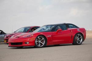 Cars on the race track and on the roads of the desert photo