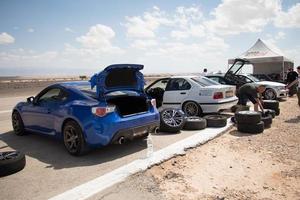 Cars on the race track and on the roads of the desert photo