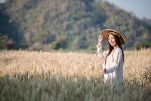 Vietnamese female farmer in wheat harvest field photo