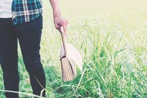 Man hands holding books on green meadow photo