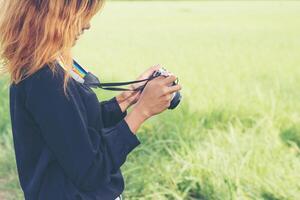 Woman with retro camera, hipster lifestyle look photo