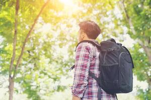 Hipster traveler man looking to nature enjoying fresh weather photo