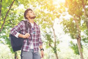 Hipster traveler man looking to nature enjoying fresh weather photo