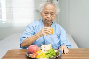 Asian senior woman patient eating breakfast photo