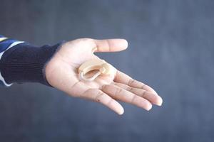 Hearing aid equipment on hand close up photo