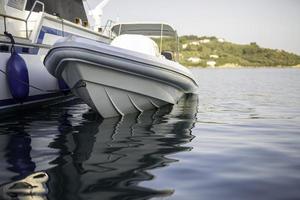 Small motorboat at the dock with beautiful reflections in the water. photo