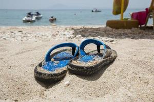 Blue flip-flop on the beach photo