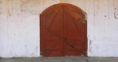 Wooden gates with stone columns. The design is vintage style. photo