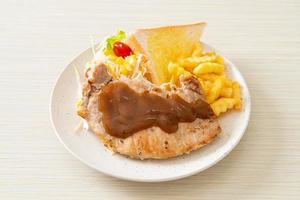 Pork steak with black peppers gravy sauce and mini salad photo