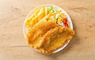 Fish and chips with mini salad on white plate photo