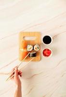 Sushi salmon set on wooden cutting board photo
