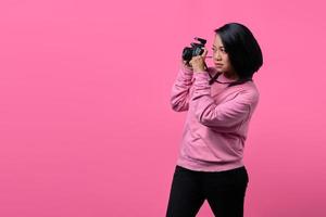 Young woman taking picture on black professional camera photo