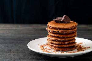 Chocolate pancake stack with chocolate powder photo