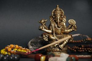 Table with occult attributes, top view. Ganesha figurine, photo