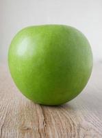 green apples on the wooden floor photo