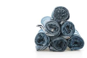 Stacks of jeans clothing on white background photo