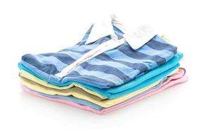 Stacks of clothing on white background photo