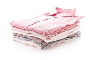 Stacks of clothing on white background photo