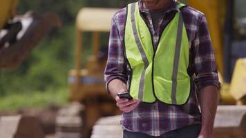 Construction worker talking on cell phone video