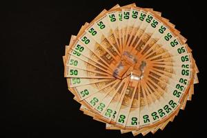 winning the lottery, euro on a black background, texture of money. photo