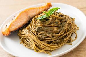 Homemade pesto spaghetti pasta with grilled salmon - Italian food style
