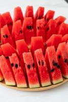 Fresh watermelon sliced on wooden plate photo