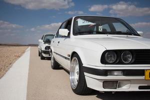 Cars on the race track and on the roads of the desert photo