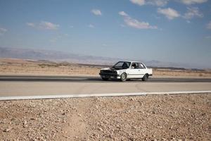 Cars on the race track and on the roads of the desert photo