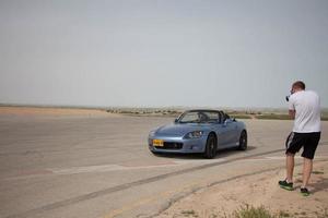 Cars on the race track and on the roads of the desert photo