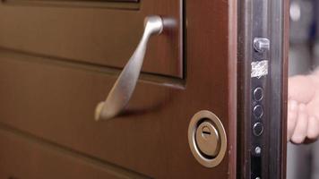 man locks the door of the house with the key video