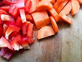 Chopped Pepper and Carrot on Kitchen Table photo