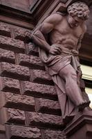 Greek God Statue on a Brick Building photo