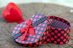 Heart Shape of Gift Box on Wood Trunk photo