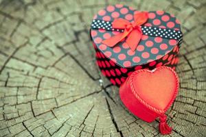 Heart Shape of Gift Box on Wood Trunk photo