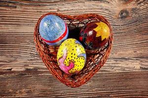 Colorful Paschal Easter Eggs in Heart Basket photo