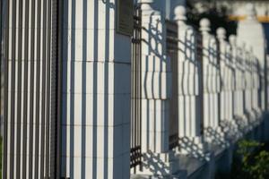 Stone fence on the street enclosing the territory. photo