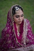 Indian bridal sitting on ground photo