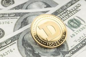 Dogecoin coin on dollar banknotes. Cryptocurrency on US dollar bills