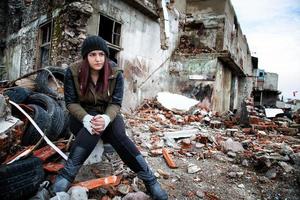 Rundown Wrecke Building Area and Young Sad Woman photo