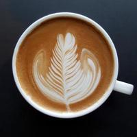 Top view of a mug of latte art coffee. photo