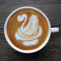 Top view of a mug of latte art coffee. photo