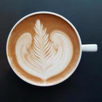 Top view of a mug of latte art coffee. photo