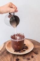 Ice coffee drink with foam and coffee beans photo