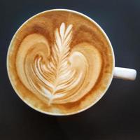 Top view of a mug of latte art coffee. photo