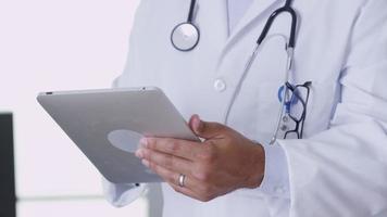 Closeup of doctor using digital tablet video