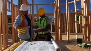 Construction workers using digital tablet on job site video